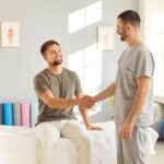 Happy,Patient,And,Rehabilitation,Therapy,Professional,Trainer,Nurse,Hand,Shake,