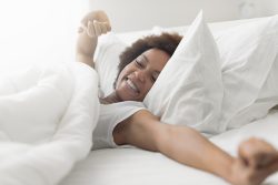 Beautiful,Woman,Waking,Up,In,Her,Bed,,She,Is,Smiling